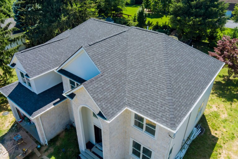 Aerial view of asphalt shingles roofing construction, the house with new window